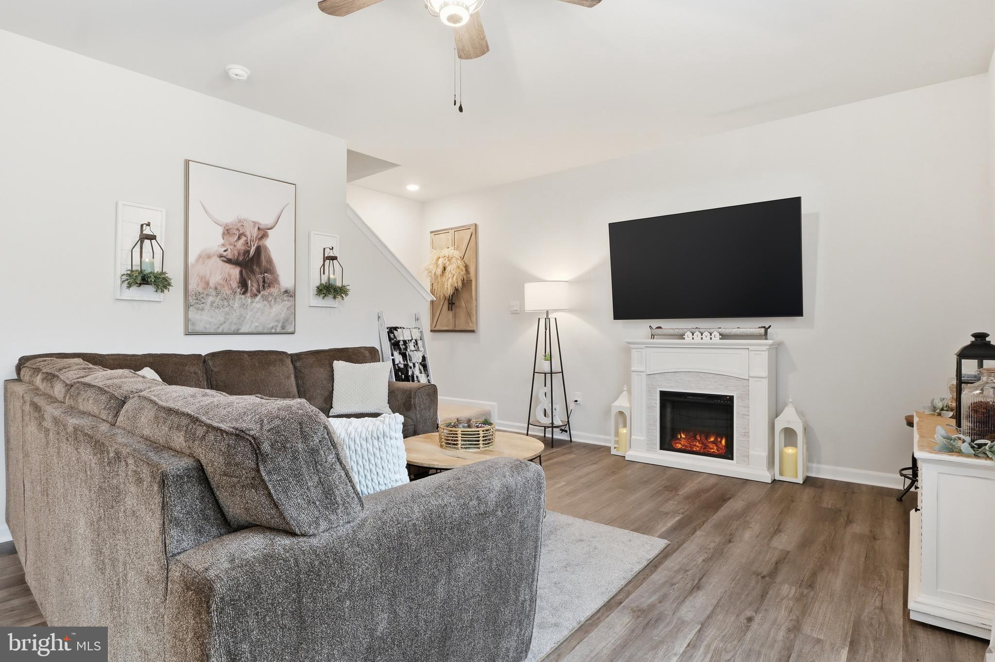 4301 Brent Drive Spring Grove, PA 17362 - Photo 15 of 49 a living room with furniture a fireplace and a flat screen tv