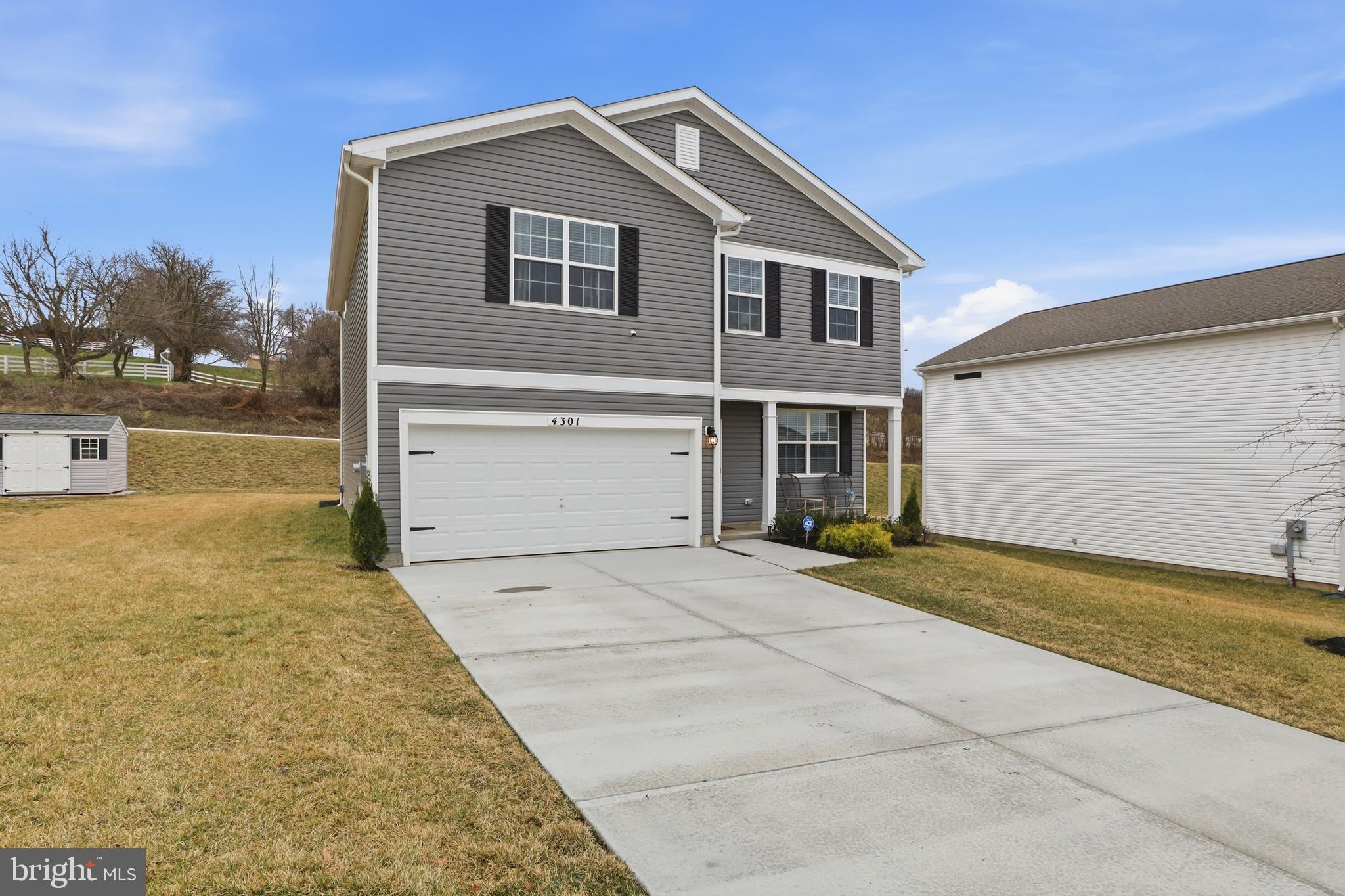 4301 Brent Drive Spring Grove, PA 17362 - Photo 43 of 49 a front view of a house with a yard and garage