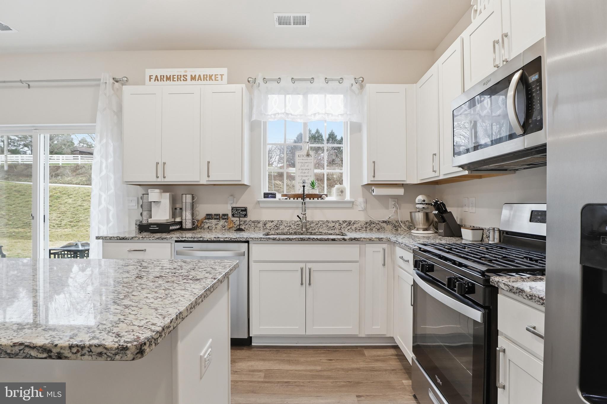 4301 Brent Drive Spring Grove, PA 17362 - Photo 8 of 49 a kitchen with stainless steel appliances granite countertop a stove sink and cabinets