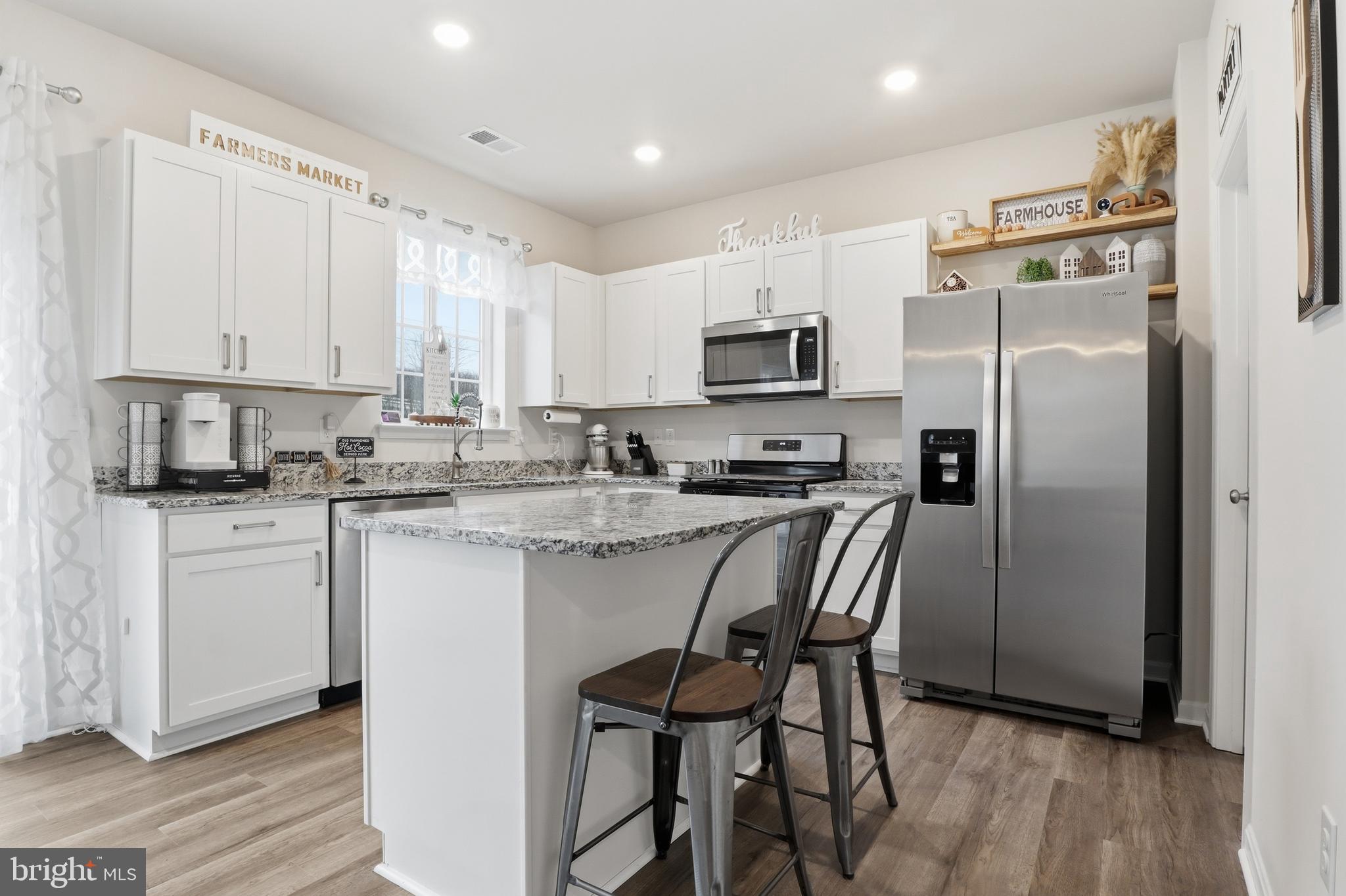 4301 Brent Drive Spring Grove, PA 17362 - Photo 10 of 49 a kitchen with kitchen island white cabinets and stainless steel appliances