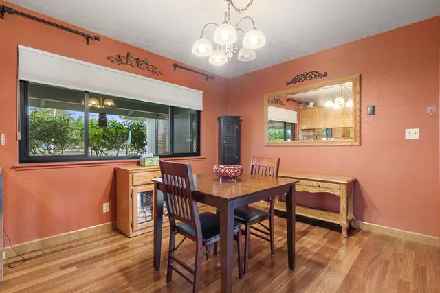 a view of a dining room with furniture wooden floor and chandelier