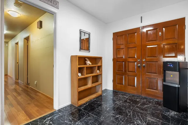 a bedroom with a large bed and a chandelier