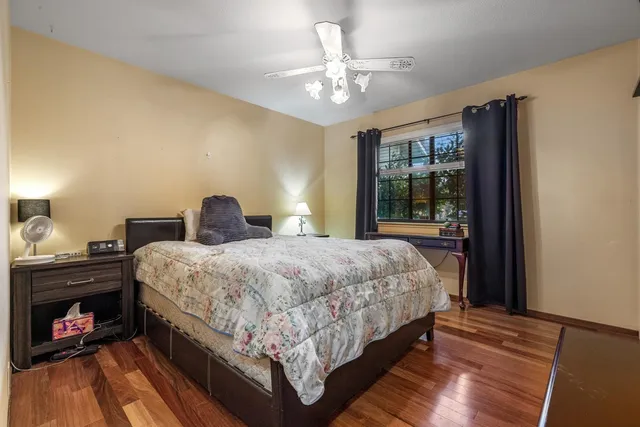a bedroom with a bed and ceiling fan