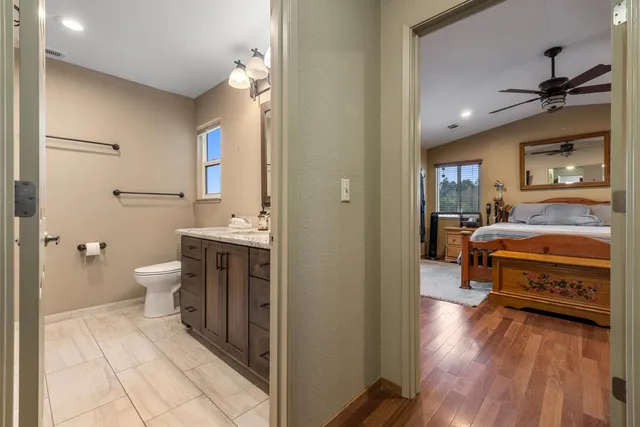 a view of a hallway with wooden floor and closet