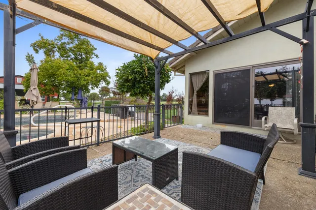 a view of a house with a yard and sitting area