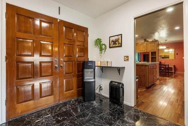 a kitchen with stainless steel appliances kitchen island granite countertop a stove sink and cabinets