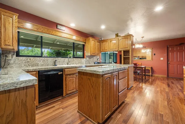 a kitchen with stainless steel appliances granite countertop a sink and cabinets