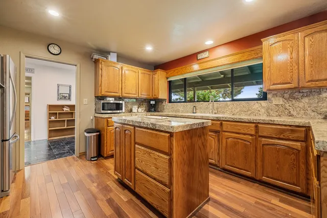 a kitchen with granite countertop sink and cabinets