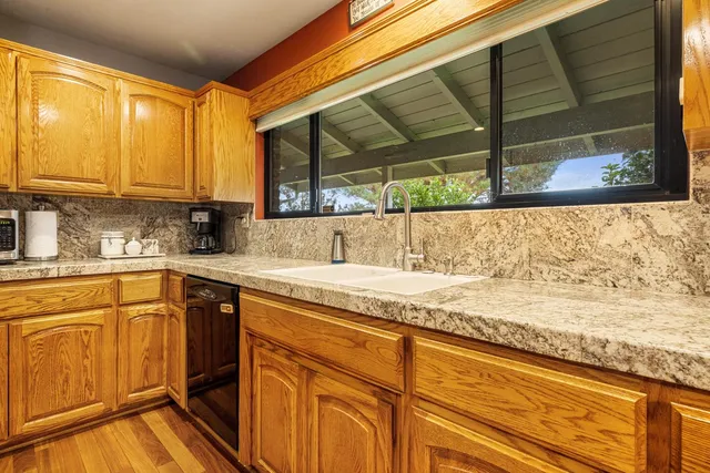 a dining area with a table chairs and a kitchen view