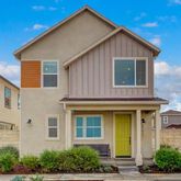a view of a brick house with potted plants