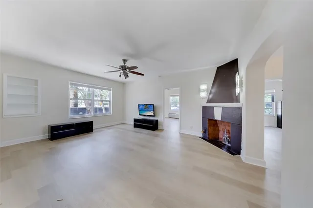 a view of a livingroom with a fireplace a window and a fireplace