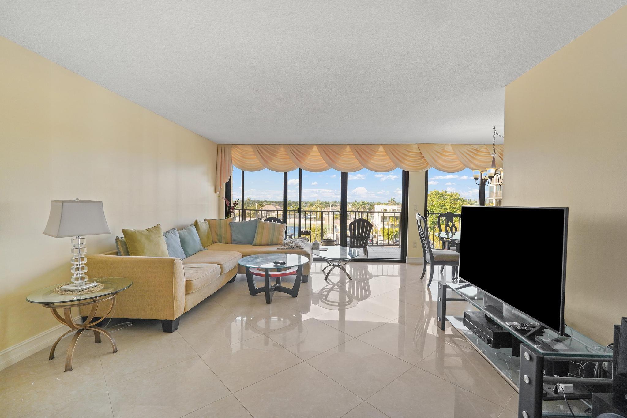 859 Jeffery Street, Unit 506 Boca Raton, FL 33487 - Photo 11 of 80 a living room with furniture and a flat screen tv