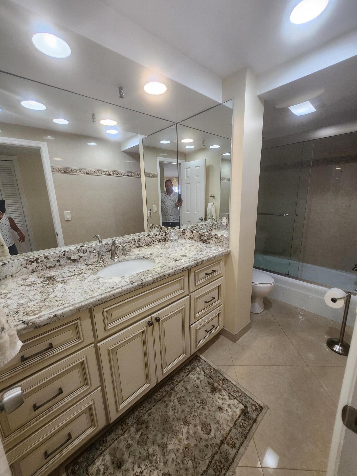 859 Jeffery Street, Unit 506 Boca Raton, FL 33487 - Photo 29 of 80 a bathroom with a granite countertop sink and a mirror