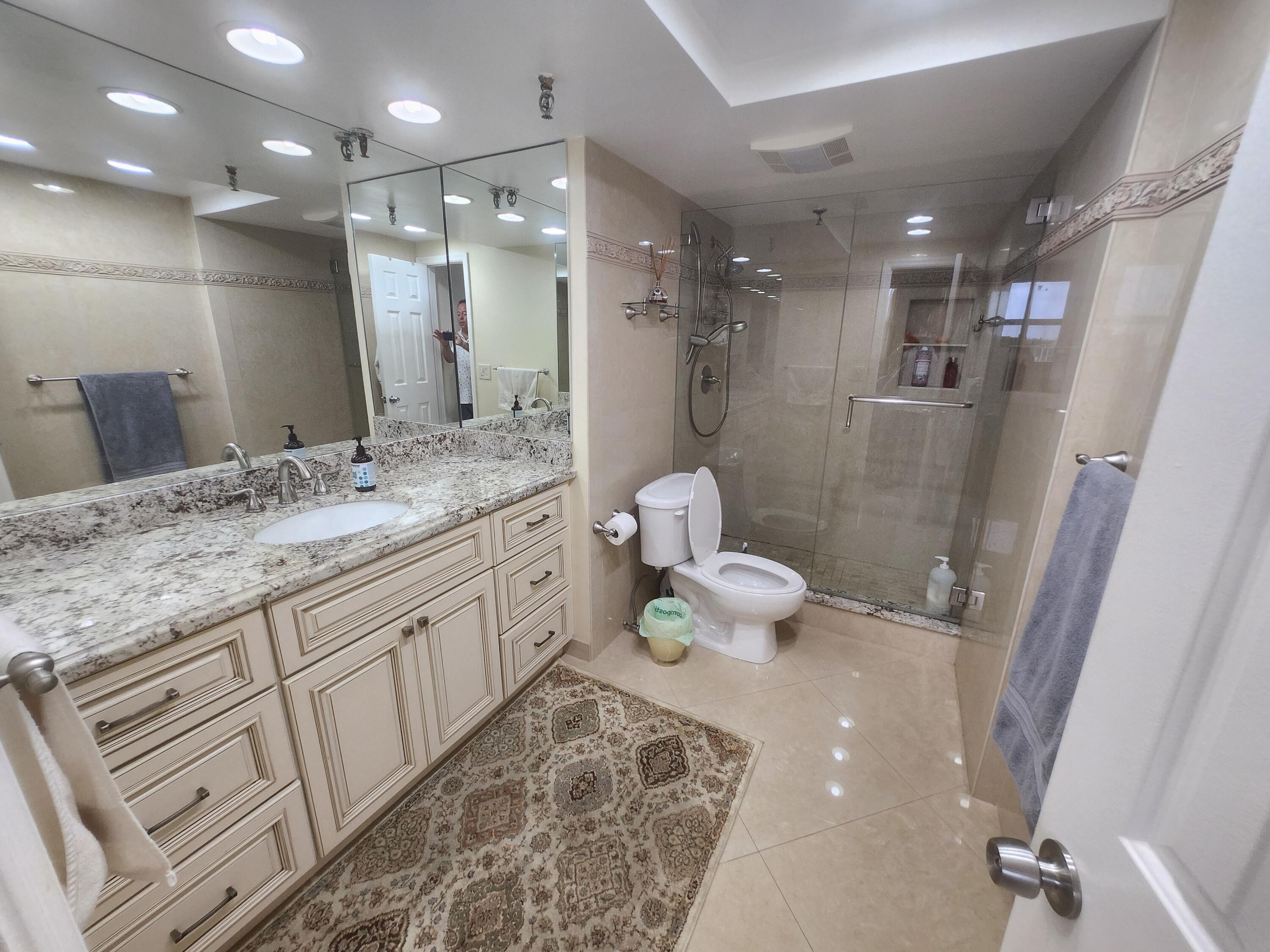 859 Jeffery Street, Unit 506 Boca Raton, FL 33487 - Photo 31 of 80 a bathroom with a double vanity sink toilet and shower