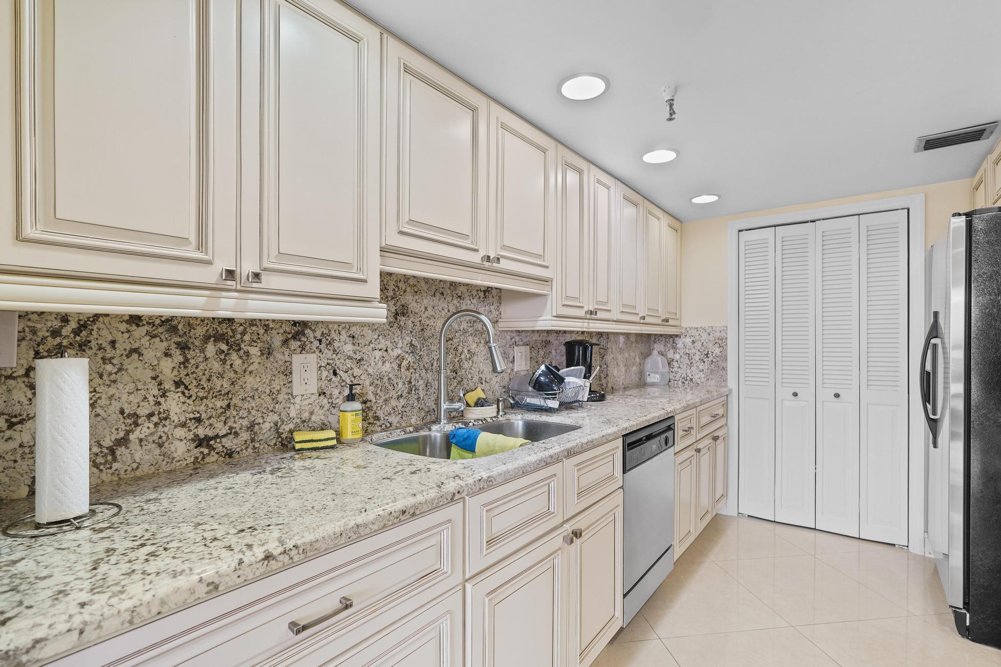 859 Jeffery Street, Unit 506 Boca Raton, FL 33487 - Photo 6 of 80 a kitchen with stainless steel appliances granite countertop a sink and cabinets
