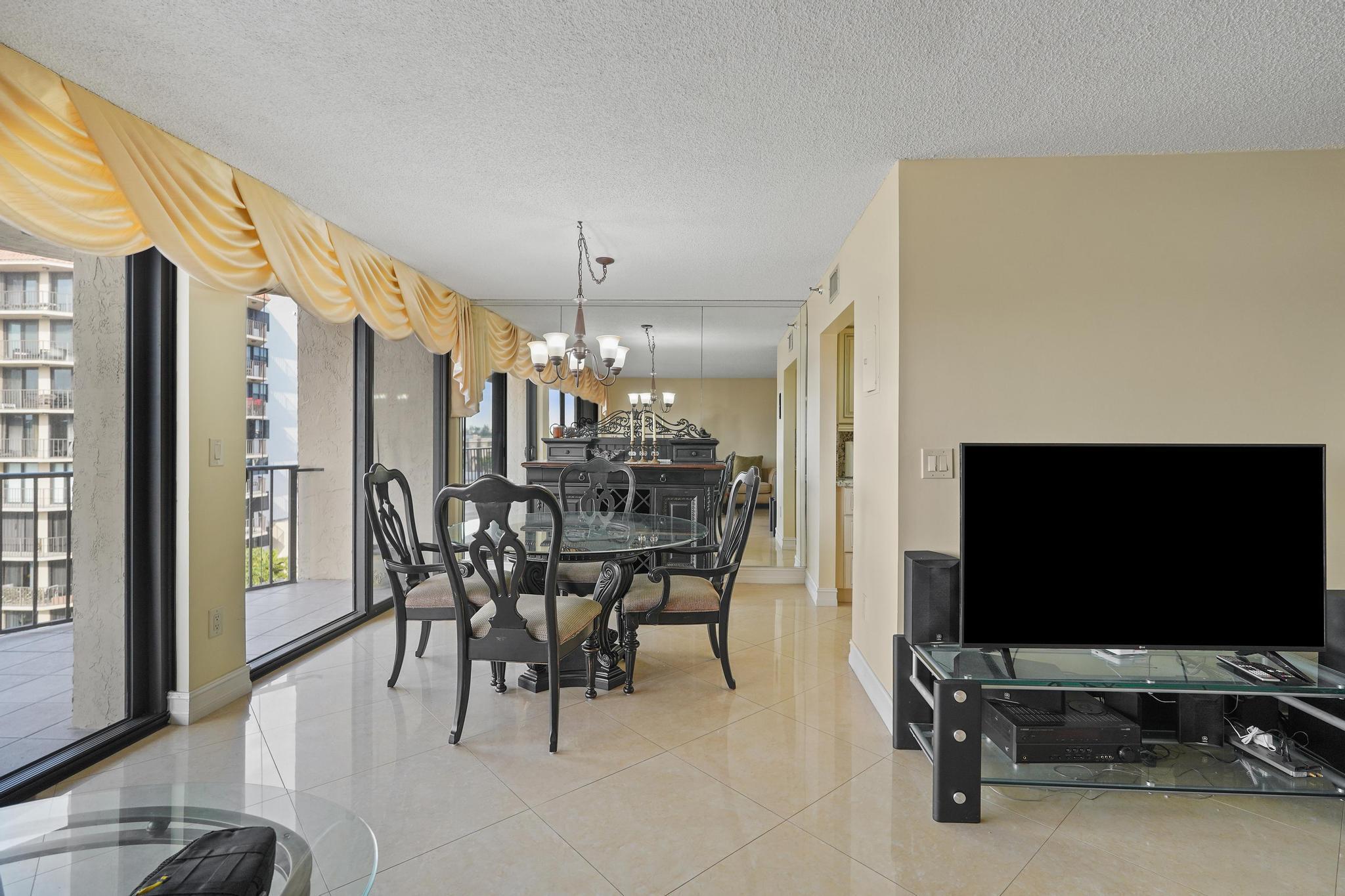 859 Jeffery Street, Unit 506 Boca Raton, FL 33487 - Photo 10 of 80 a view of a livingroom with furniture and a flat screen tv
