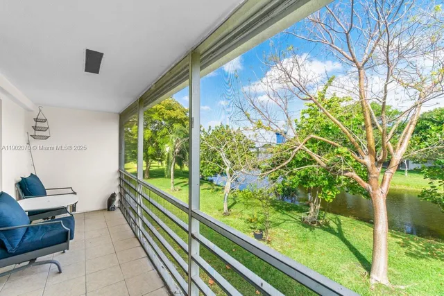 a city view from a balcony with furniture