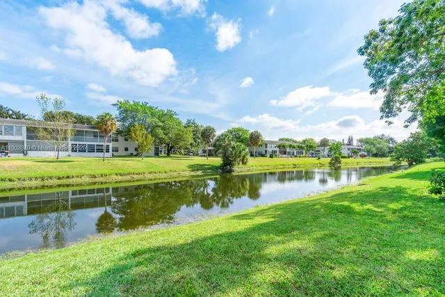 a view of a lake with houses in the background