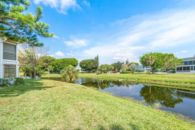 a view of swimming pool is middle in the garden