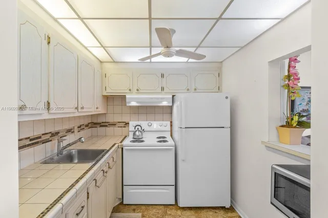 a view of a kitchen with electric appliances