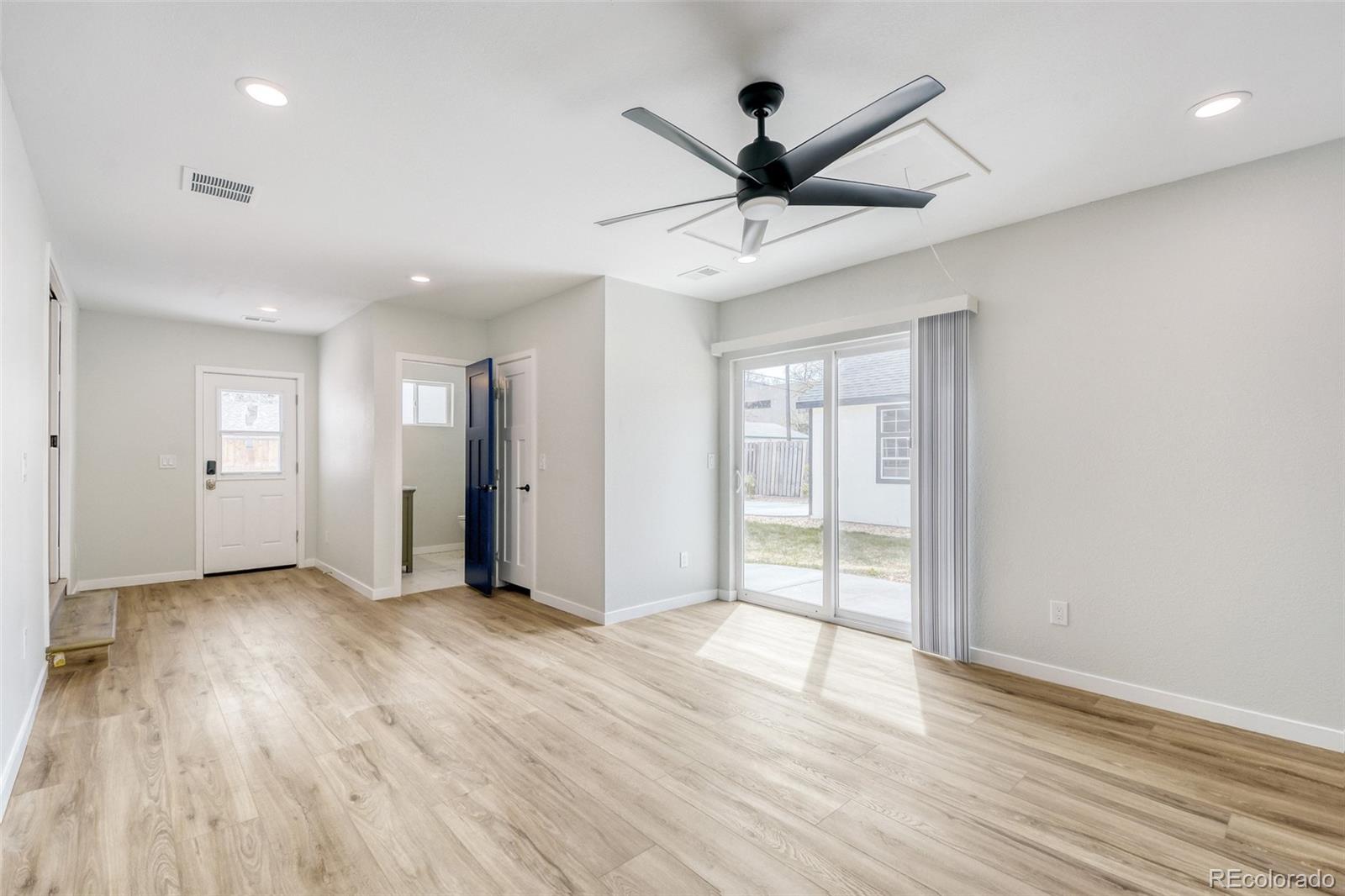 321 West Mulberry Street Fort Collins, CO 80521 - Photo 16 of 32 a view of an empty room with wooden floor and a ceiling fan
