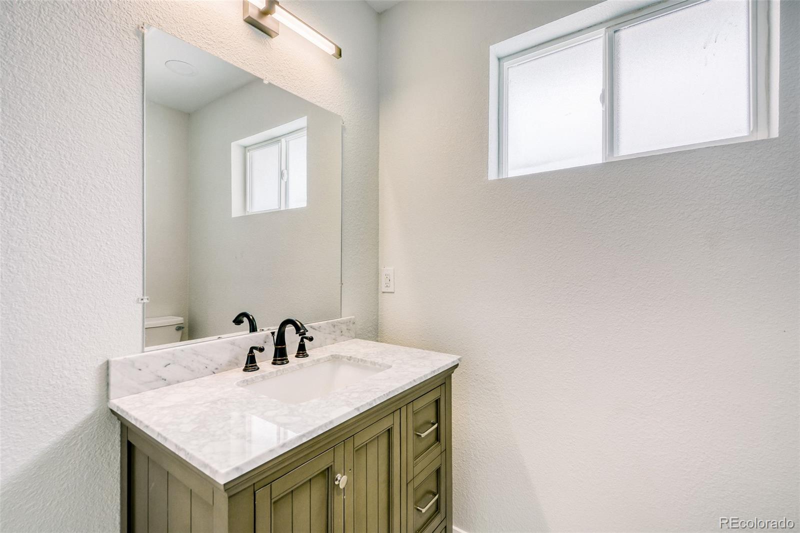 321 West Mulberry Street Fort Collins, CO 80521 - Photo 18 of 32 a bathroom with a sink and a mirror