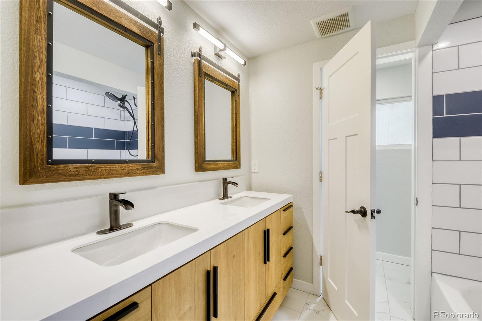 321 West Mulberry Street Fort Collins, CO 80521 - Photo 20 of 32 a bathroom with a double vanity sink mirror and