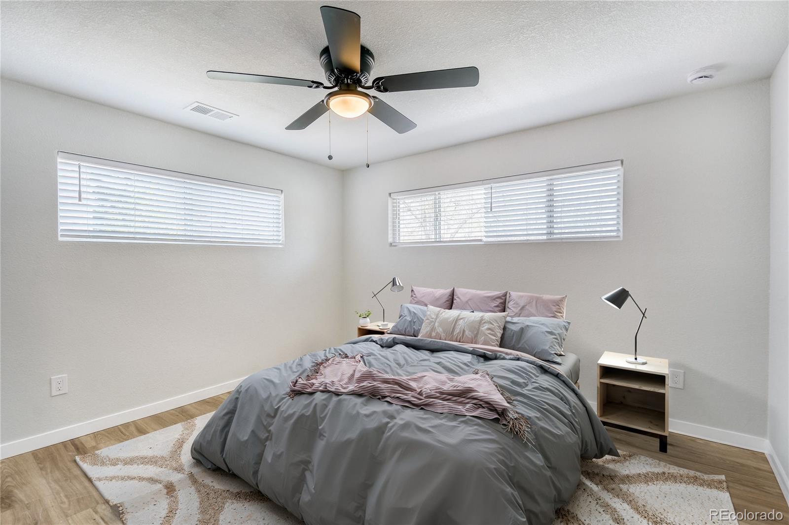 321 West Mulberry Street Fort Collins, CO 80521 - Photo 21 of 32 a bedroom with a bed and a chandelier
