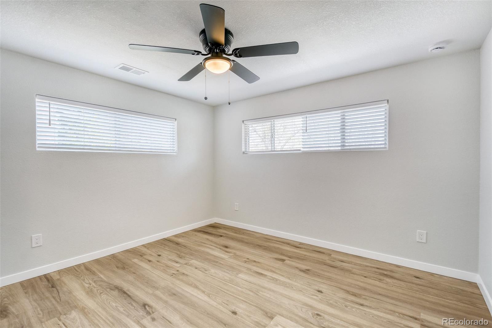 321 West Mulberry Street Fort Collins, CO 80521 - Photo 22 of 32 an empty room with wooden floor fan and windows