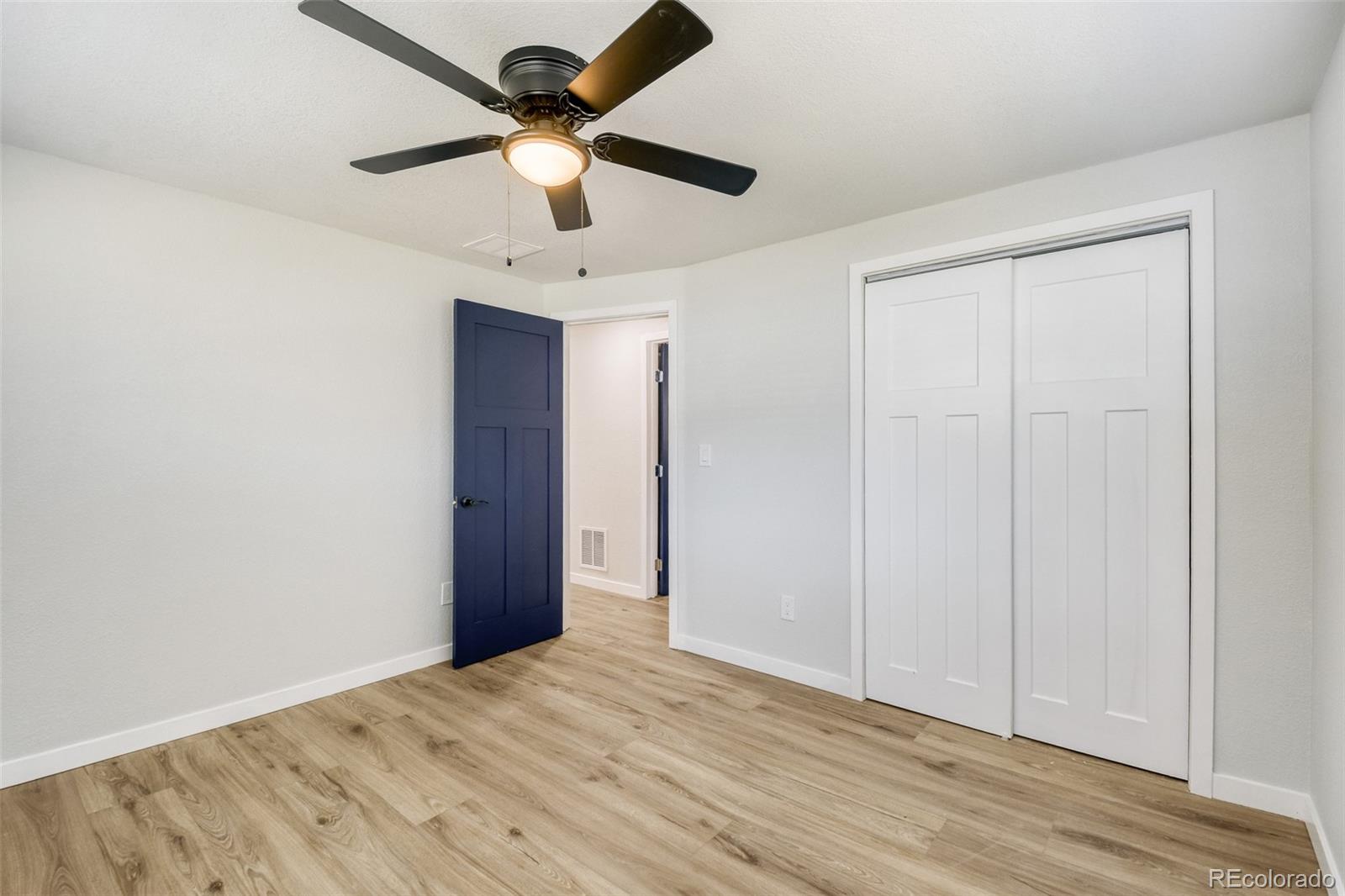 321 West Mulberry Street Fort Collins, CO 80521 - Photo 23 of 32 an empty room with wooden floor and ceiling fan