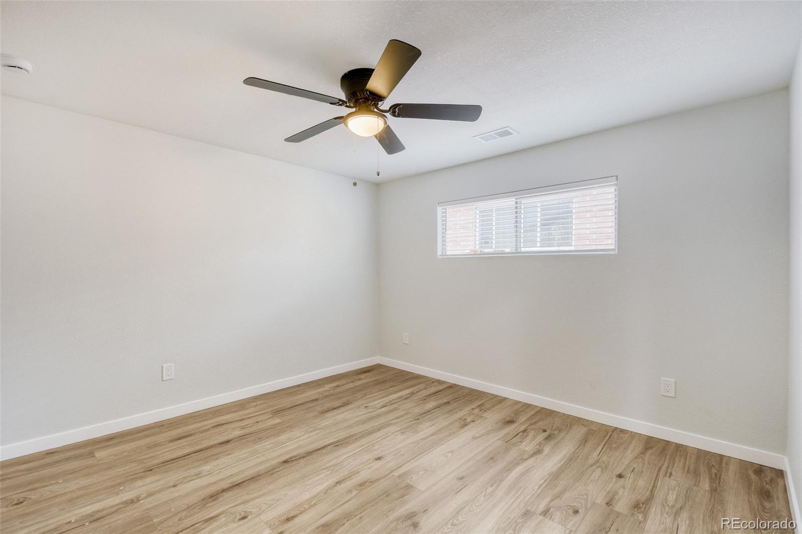 321 West Mulberry Street Fort Collins, CO 80521 - Photo 25 of 32 an empty room with wooden floor fan and windows