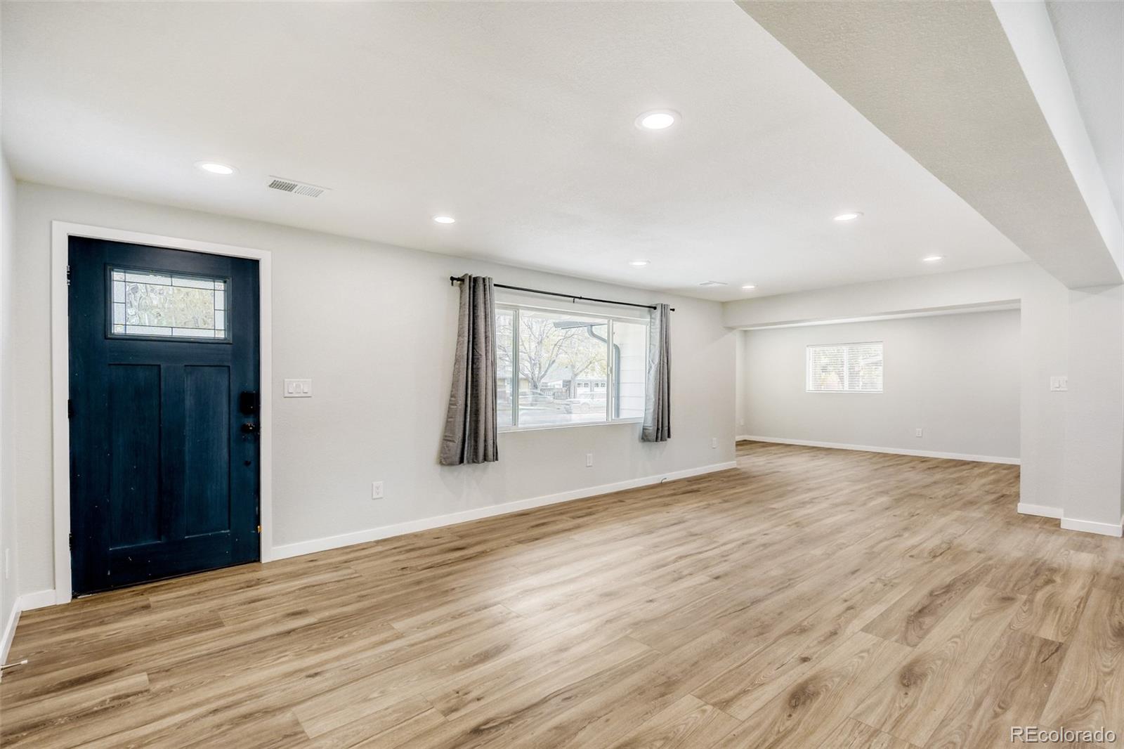321 West Mulberry Street Fort Collins, CO 80521 - Photo 5 of 32 a view of an empty room with wooden floor and windows