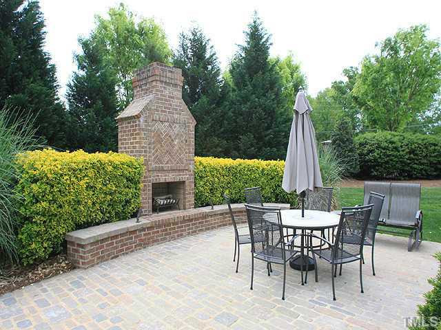 2259 Clayette Court Raleigh, NC 27612 - Photo 24 of 25 Gorgeous designer brick patio with exterior fireplace, landscaped, private, directly behind home. Patio/Deck