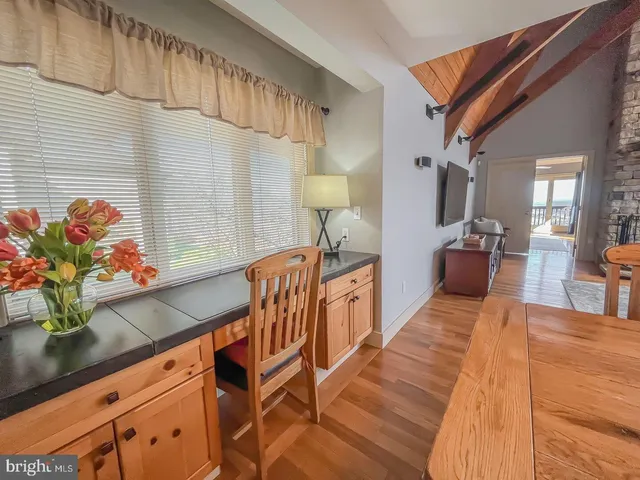 a view of a hallway with furniture and a potted plant