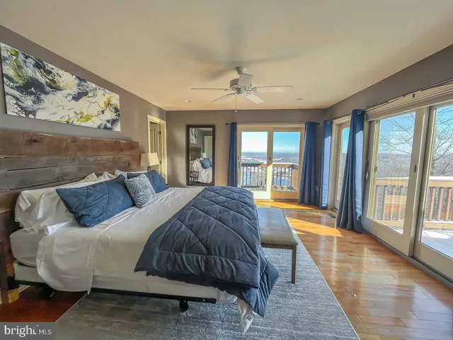 a spacious bedroom with a large bed and a large window