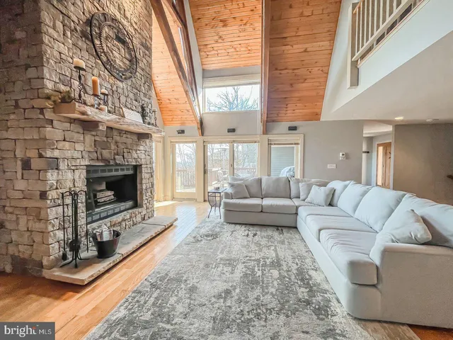 a living room with furniture a fireplace and a large window