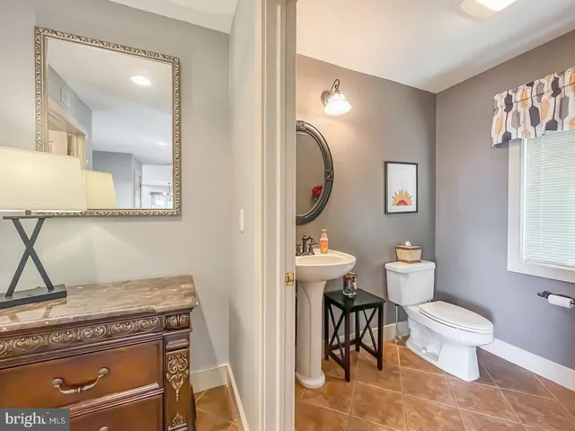 a bathroom with a toilet a sink and mirror