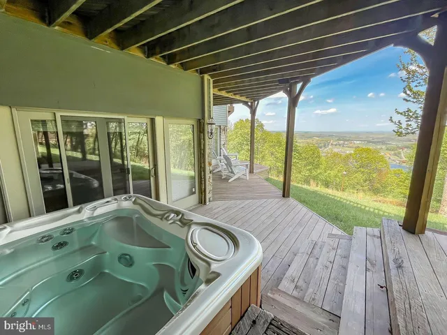 a bedroom with furniture and large windows