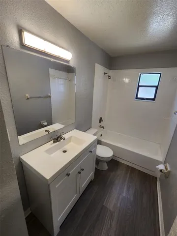 a bathroom with a double vanity sink toilet and mirror