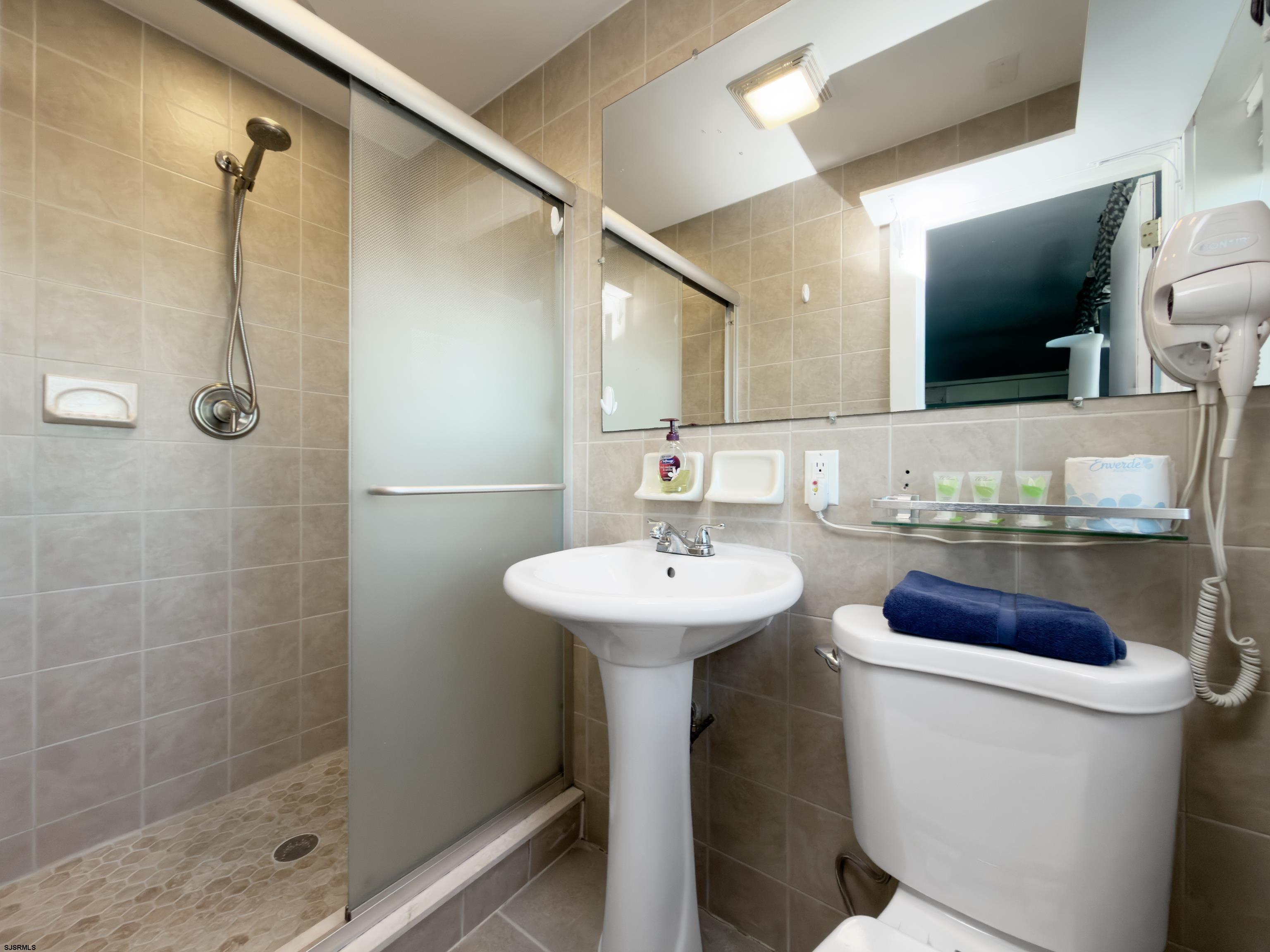 807 East 8th Street, Unit 515 Ocean City, NJ 08226 - Photo 12 of 34 a bathroom with a sink toilet and shower