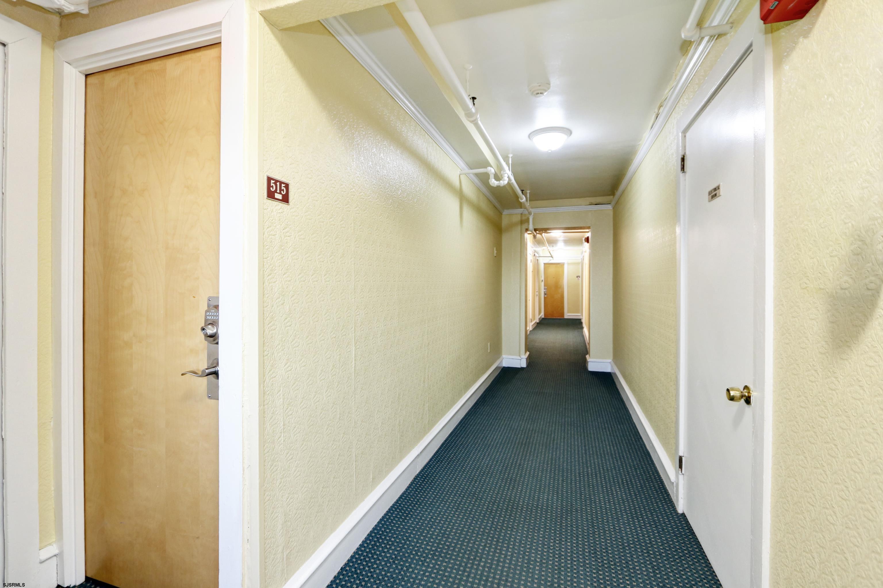 807 East 8th Street, Unit 515 Ocean City, NJ 08226 - Photo 14 of 34 a view of a hallway with wooden floor