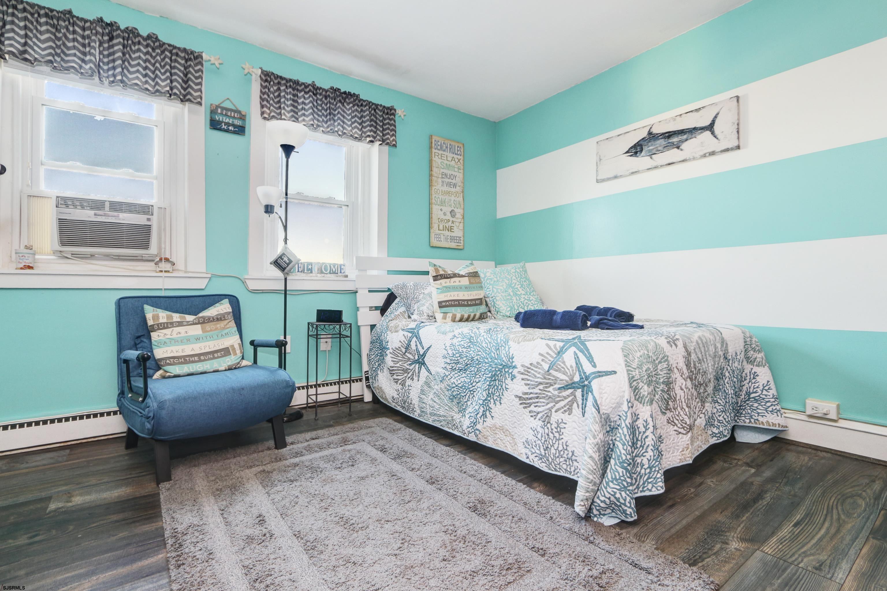 807 East 8th Street, Unit 515 Ocean City, NJ 08226 - Photo 7 of 34 a bedroom with a bed and a couch