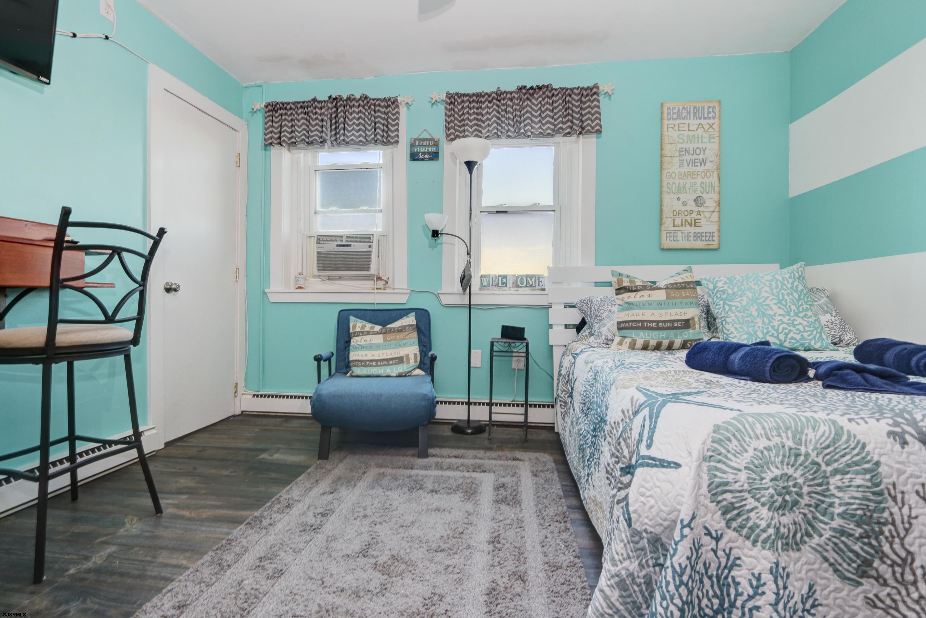 807 East 8th Street, Unit 515 Ocean City, NJ 08226 - Photo 9 of 34 a bedroom with furniture and a window