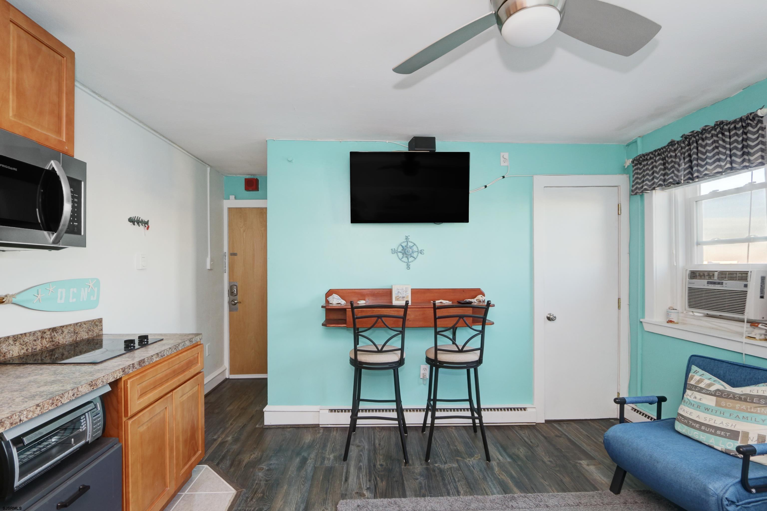 807 East 8th Street, Unit 515 Ocean City, NJ 08226 - Photo 10 of 34 a living room with furniture a flat screen tv and kitchen view