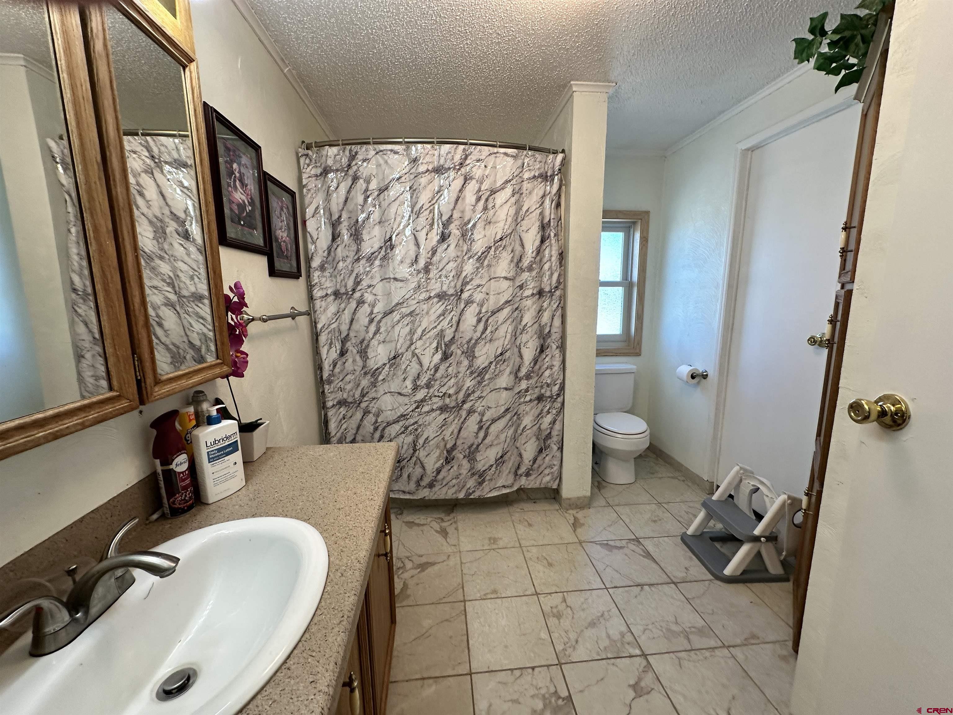 12880 2900th Road Hotchkiss, CO 81419 - Photo 11 of 22 a bathroom with a sink toilet and shower