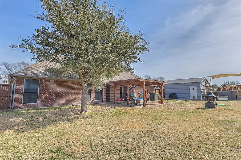 11151 County Road 213 Forney, TX 75126 - Photo 31 of 35 Rear view of property with brick siding, a patio area, a shingled roof, and a fenced backyard
