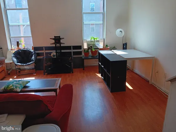 a dining room with furniture and wooden floor