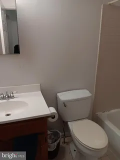 a white toilet sitting next to a bathroom sink