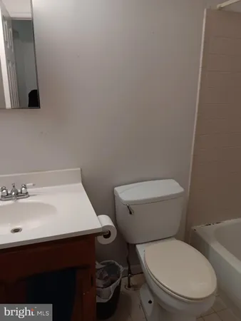 a white toilet sitting next to a bathroom sink