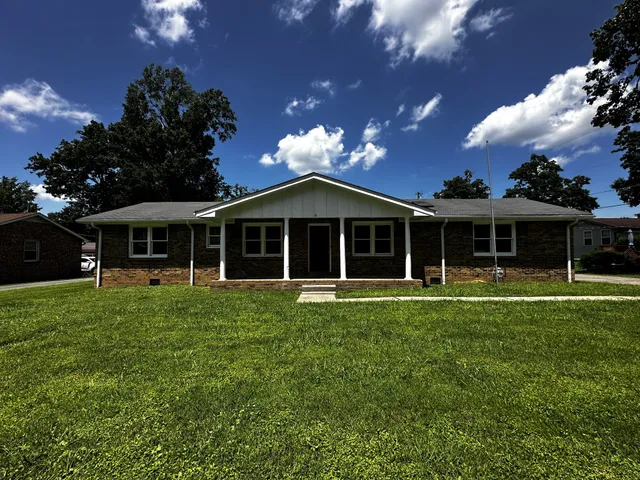 a front view of a house with a garden